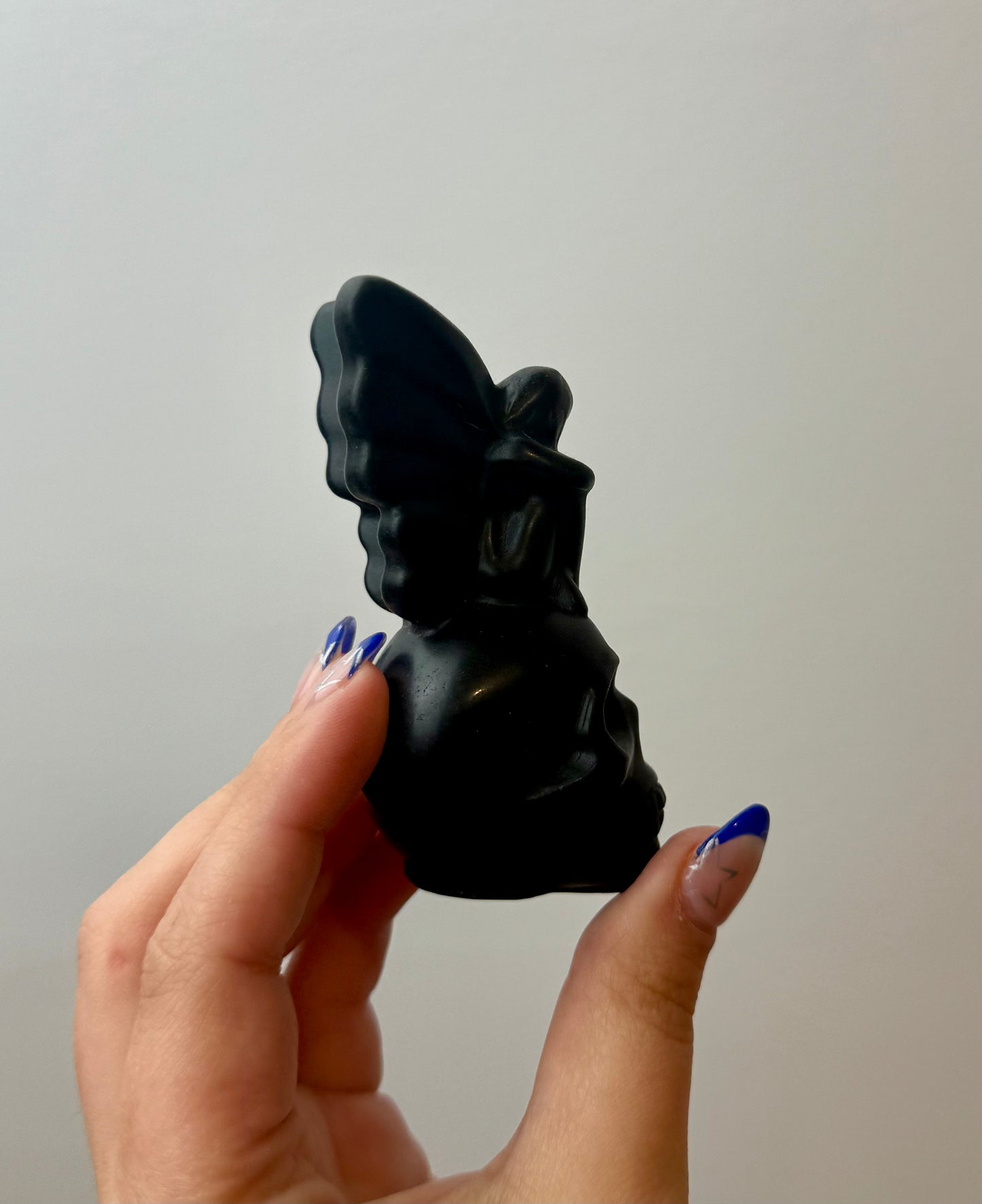 Obsidian fairy on skull carving