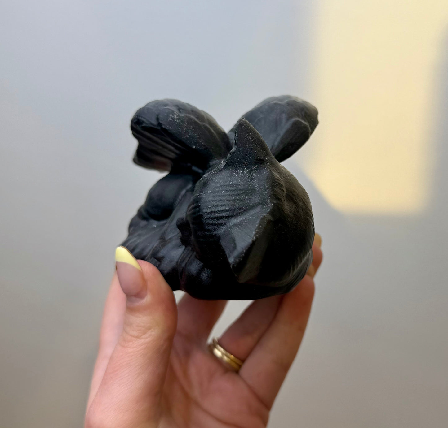 Obsidian angel cat carving