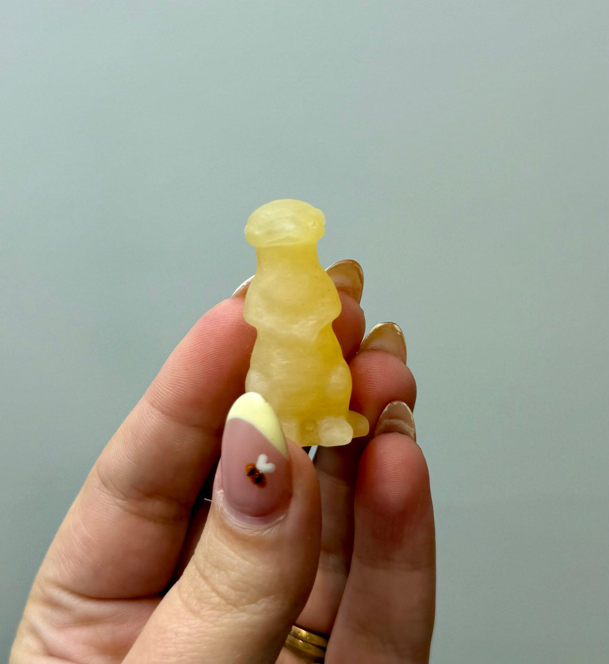 Orange calcite meerkat carving