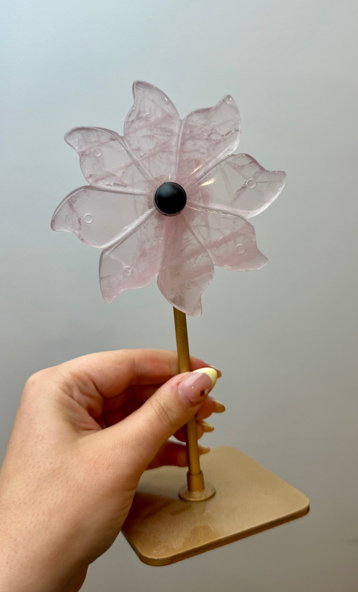 Rose quartz spinning flower carving on stand