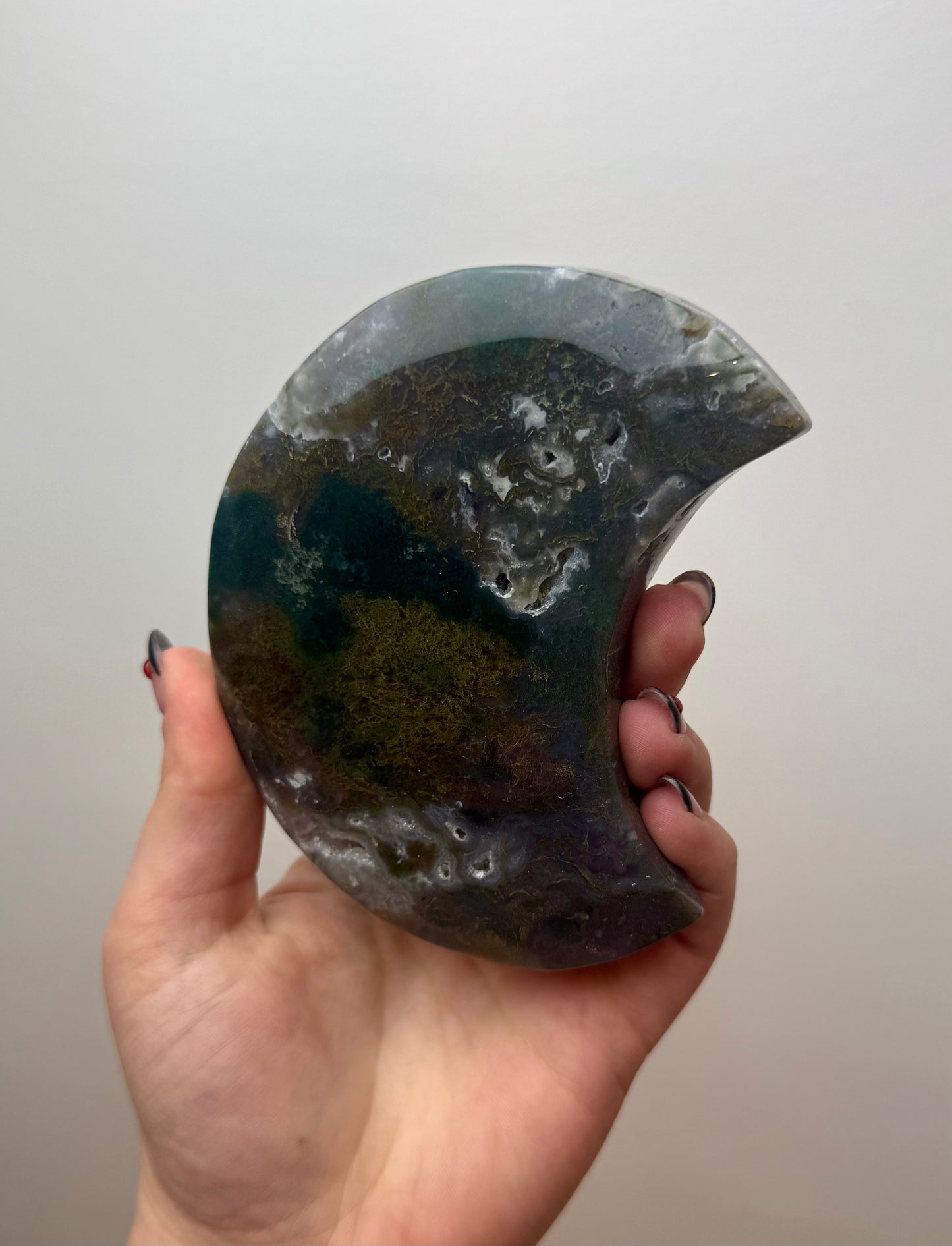 Moss agate moon carving on stand