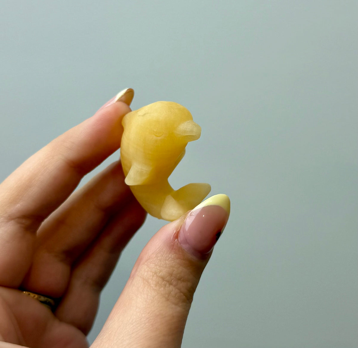 Orange calcite dolphin carving
