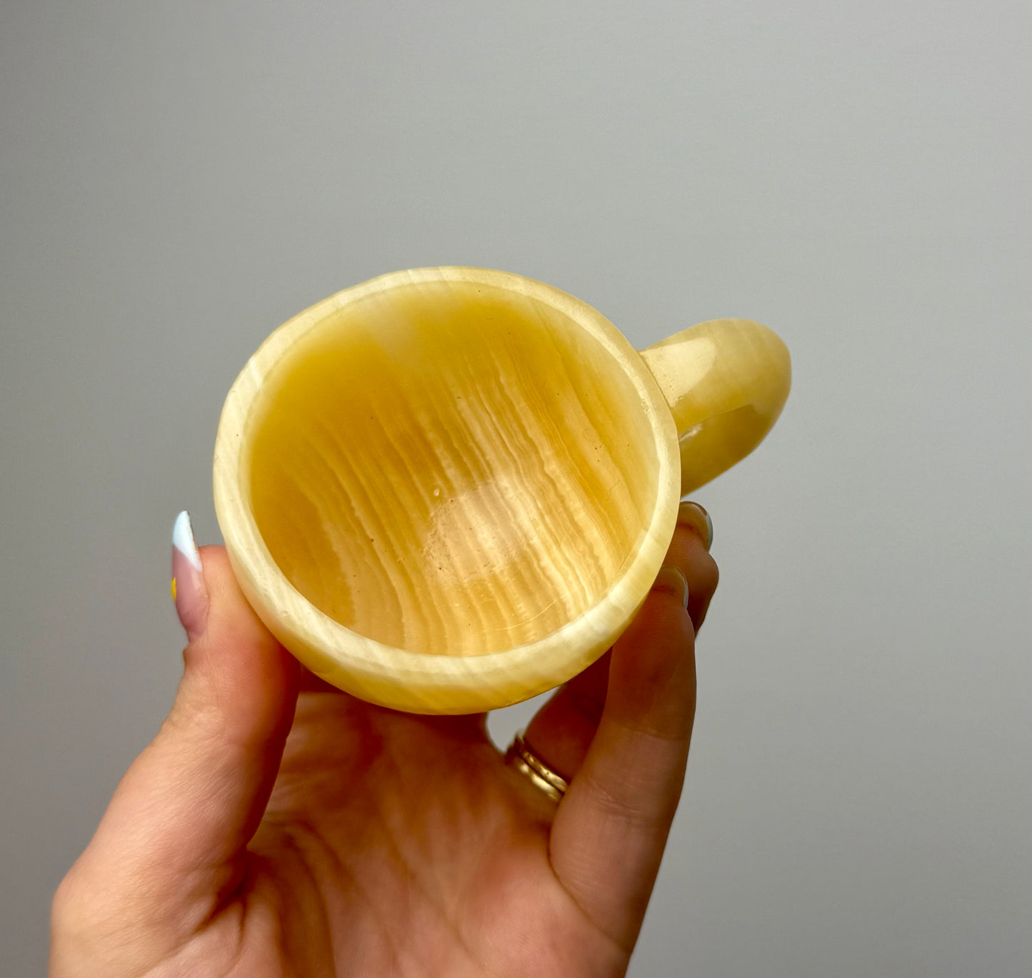 Orange calcite mug/cup carving