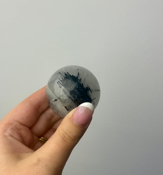 Black tourmaline in quartz sphere