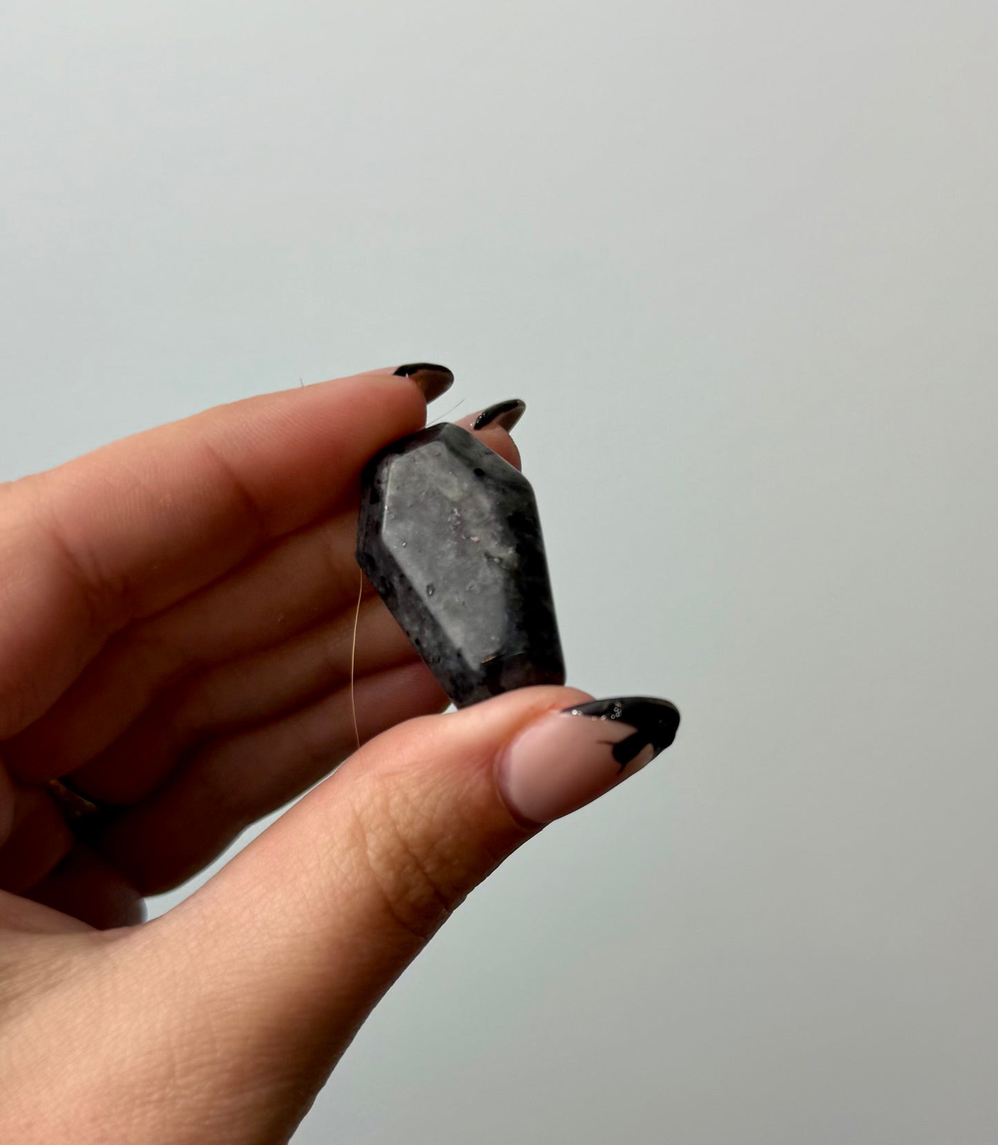 Larvikite coffin carving