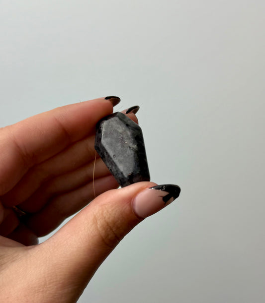 Larvikite coffin carving