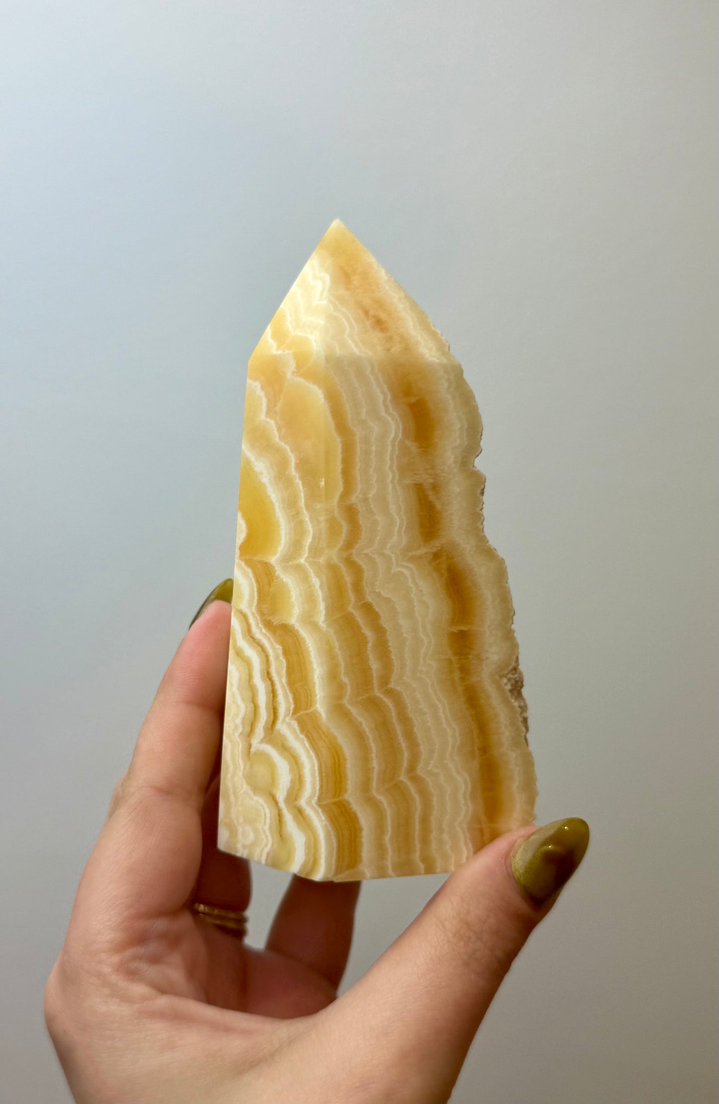 Half raw orange calcite tower