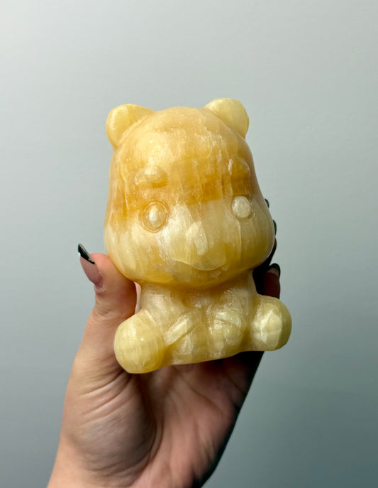 Orange calcite Winne the Pooh carving