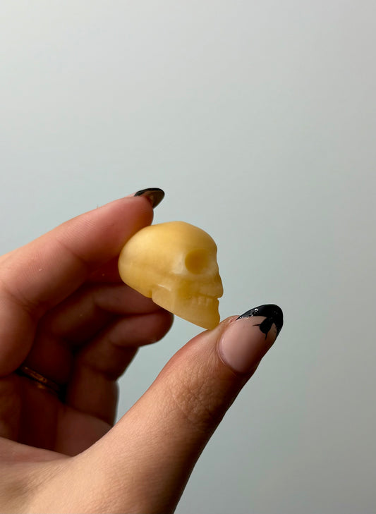 Orange calcite skull carving
