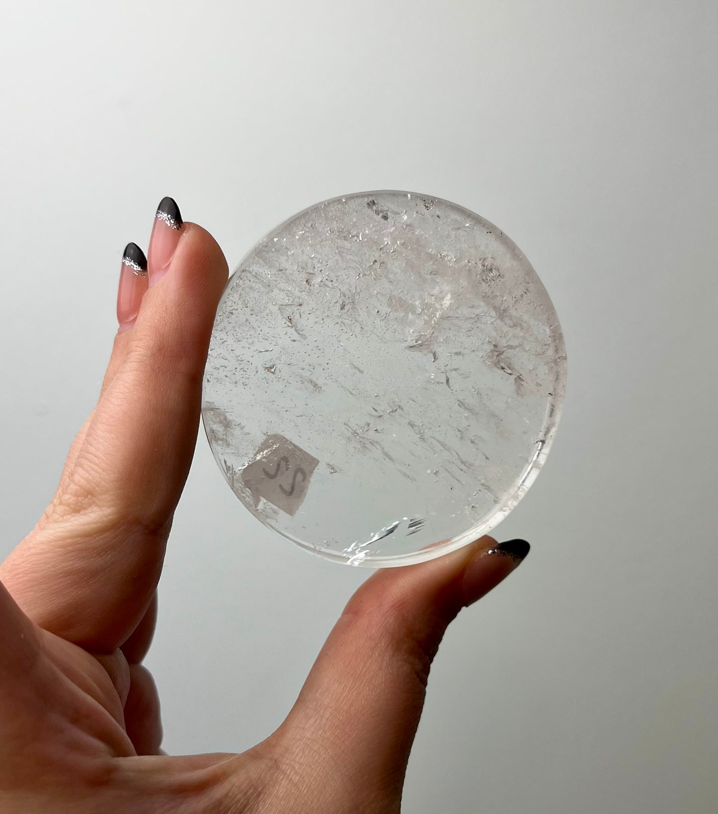 Clear quartz disk slab on stand