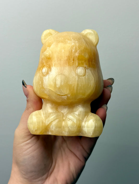 Orange calcite Winne the Pooh carving