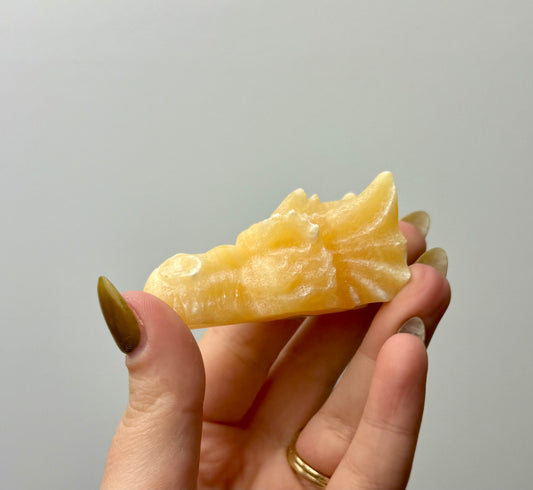 Orange calcite dragon head carving