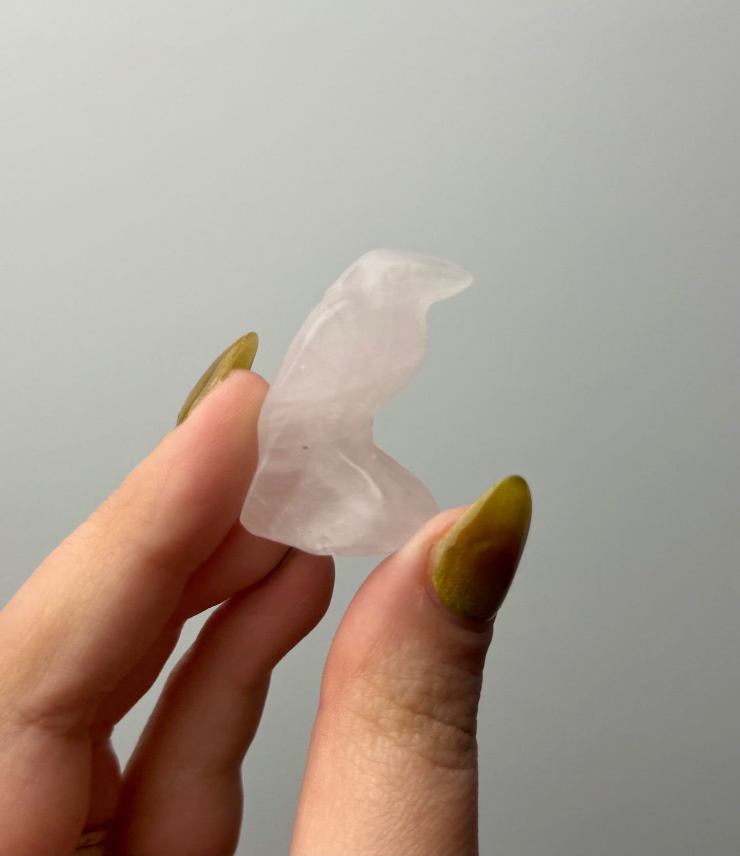 Rose quartz raven carving