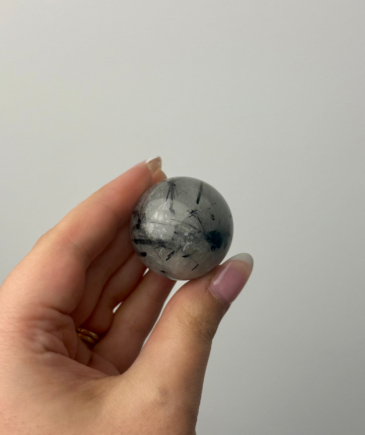 Black tourmaline in quartz sphere