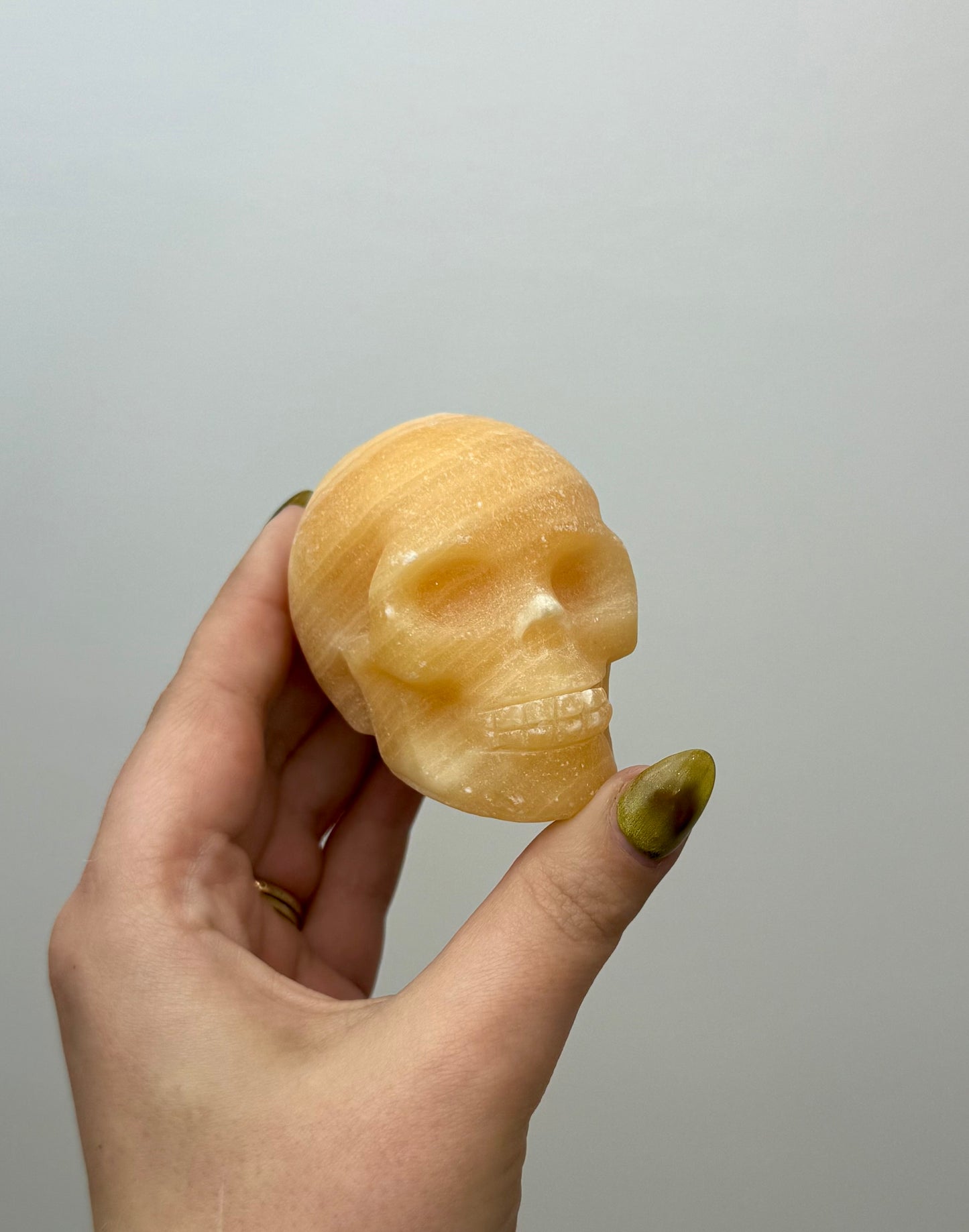 Orange calcite skull carving