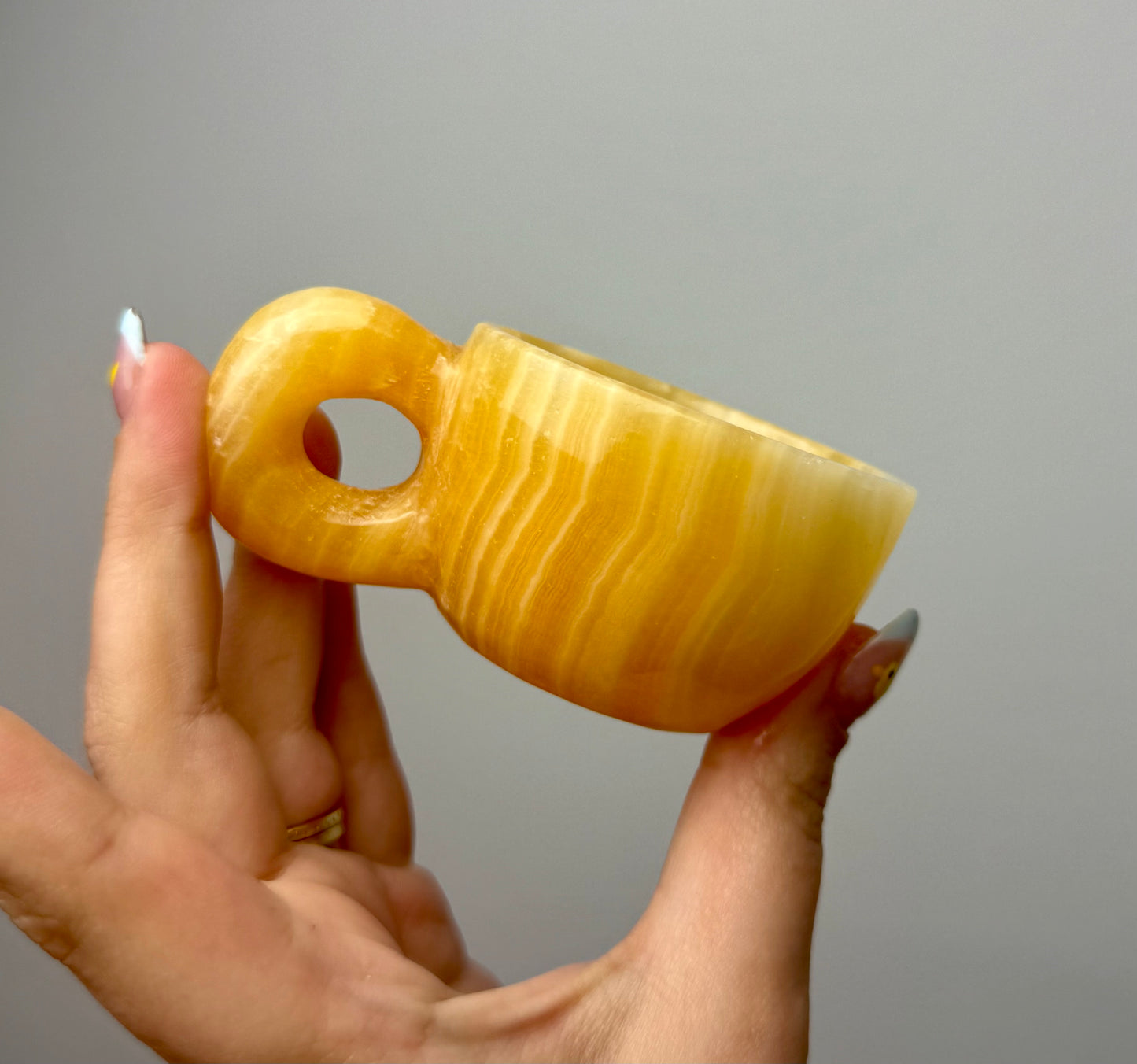 Orange calcite mug/cup carving