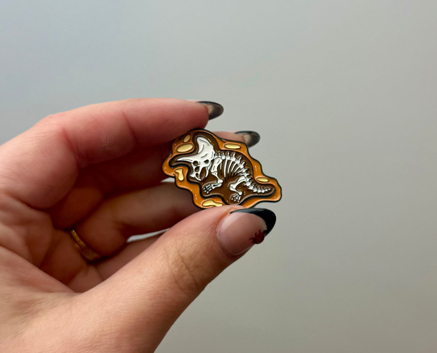 Dinosaur fossil enamel pin