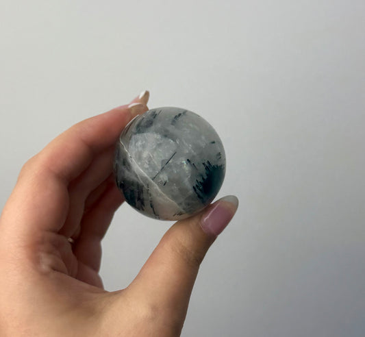 Black tourmaline in quartz sphere