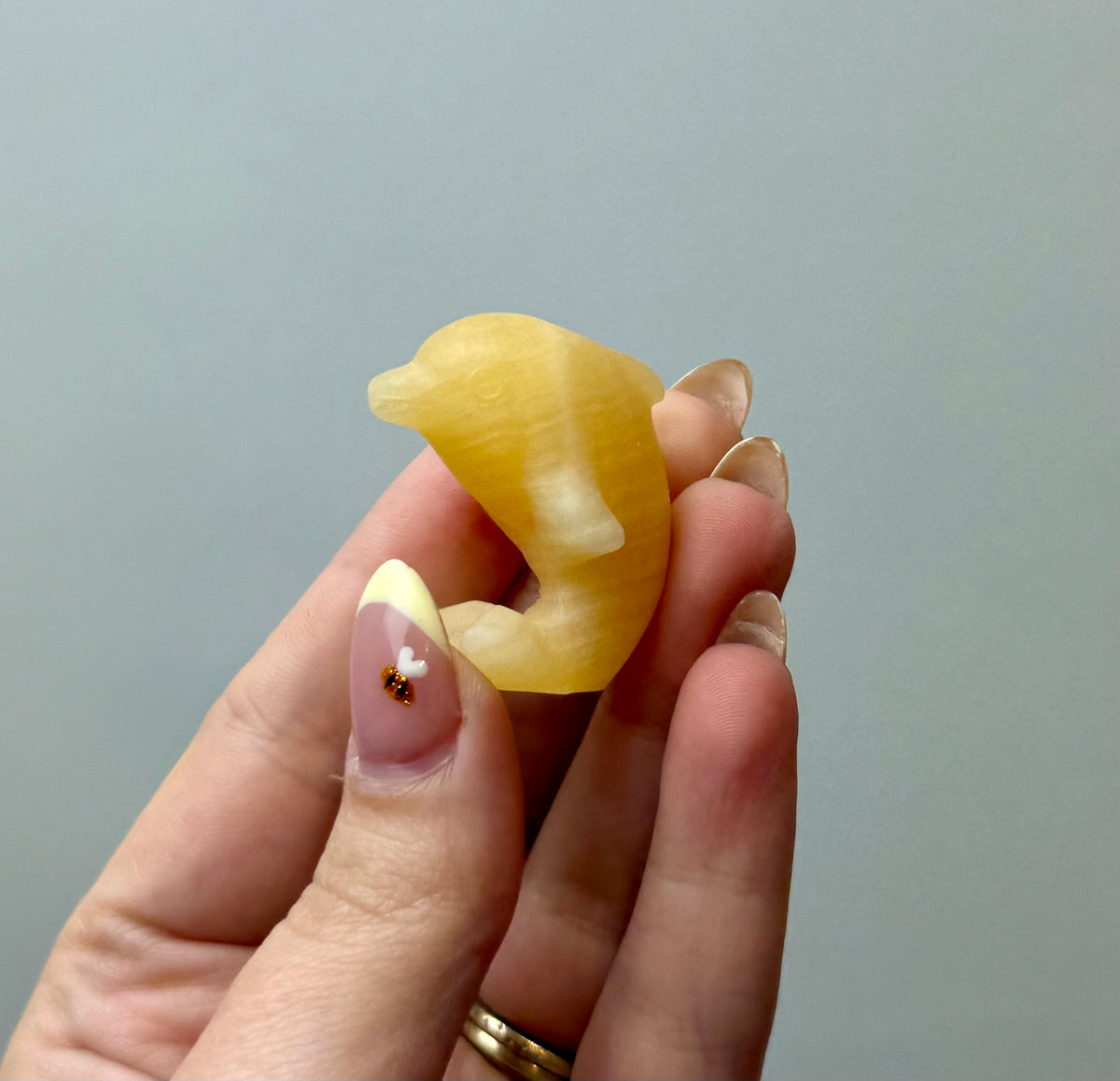 Orange calcite dolphin carving