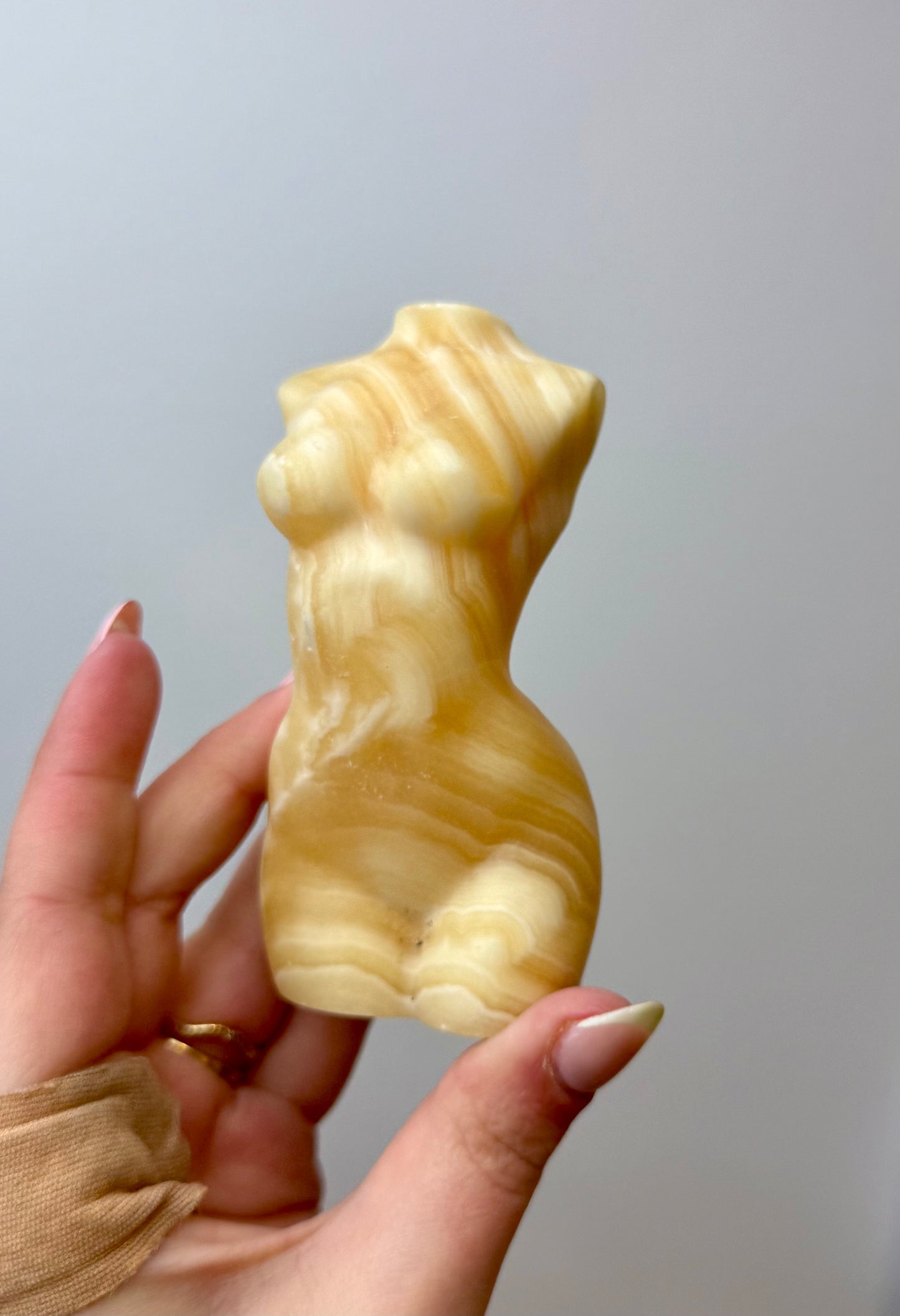 Orange calcite woman body carving
