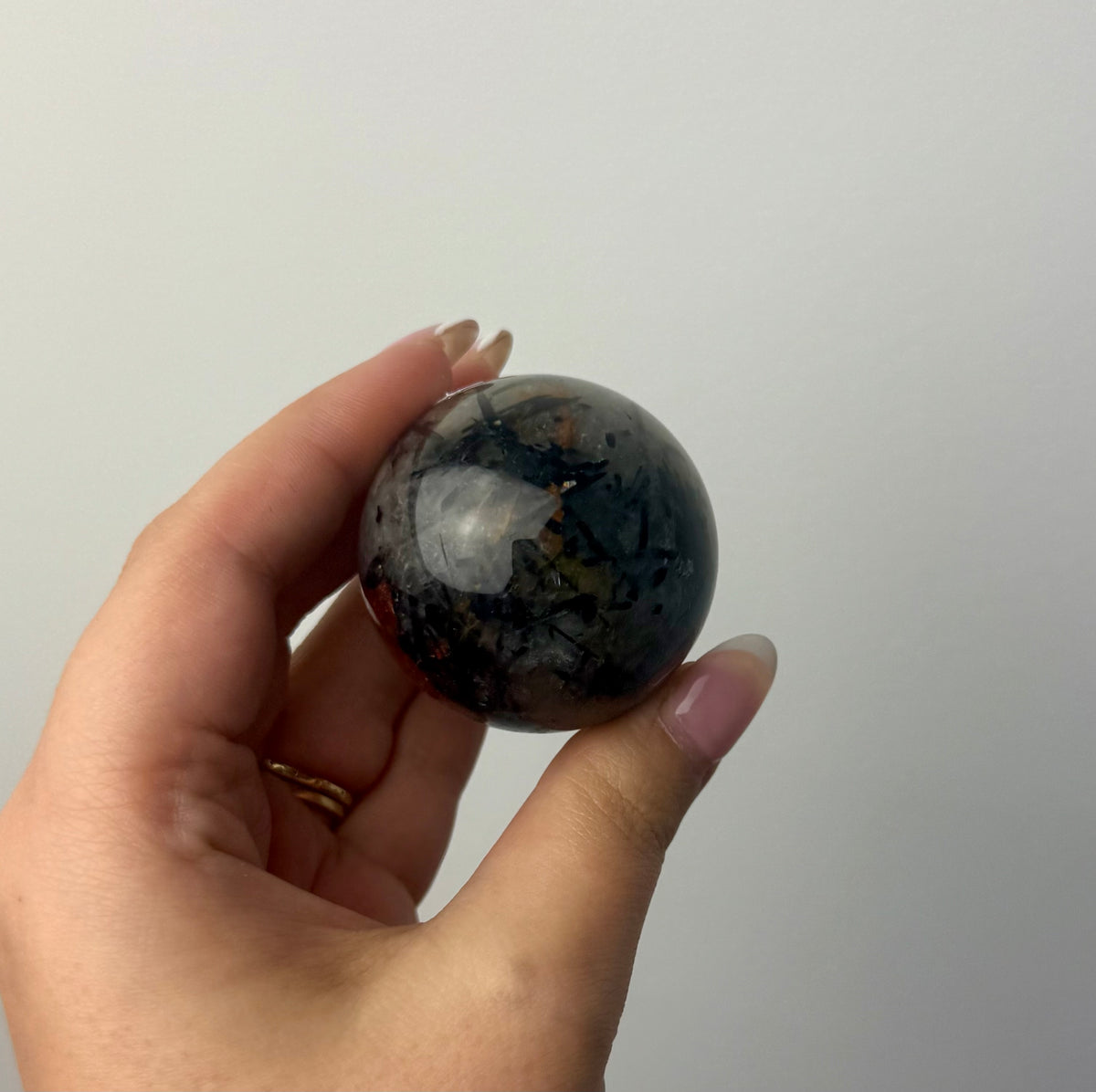 Black tourmaline in quartz sphere