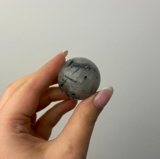 Black tourmaline in quartz sphere