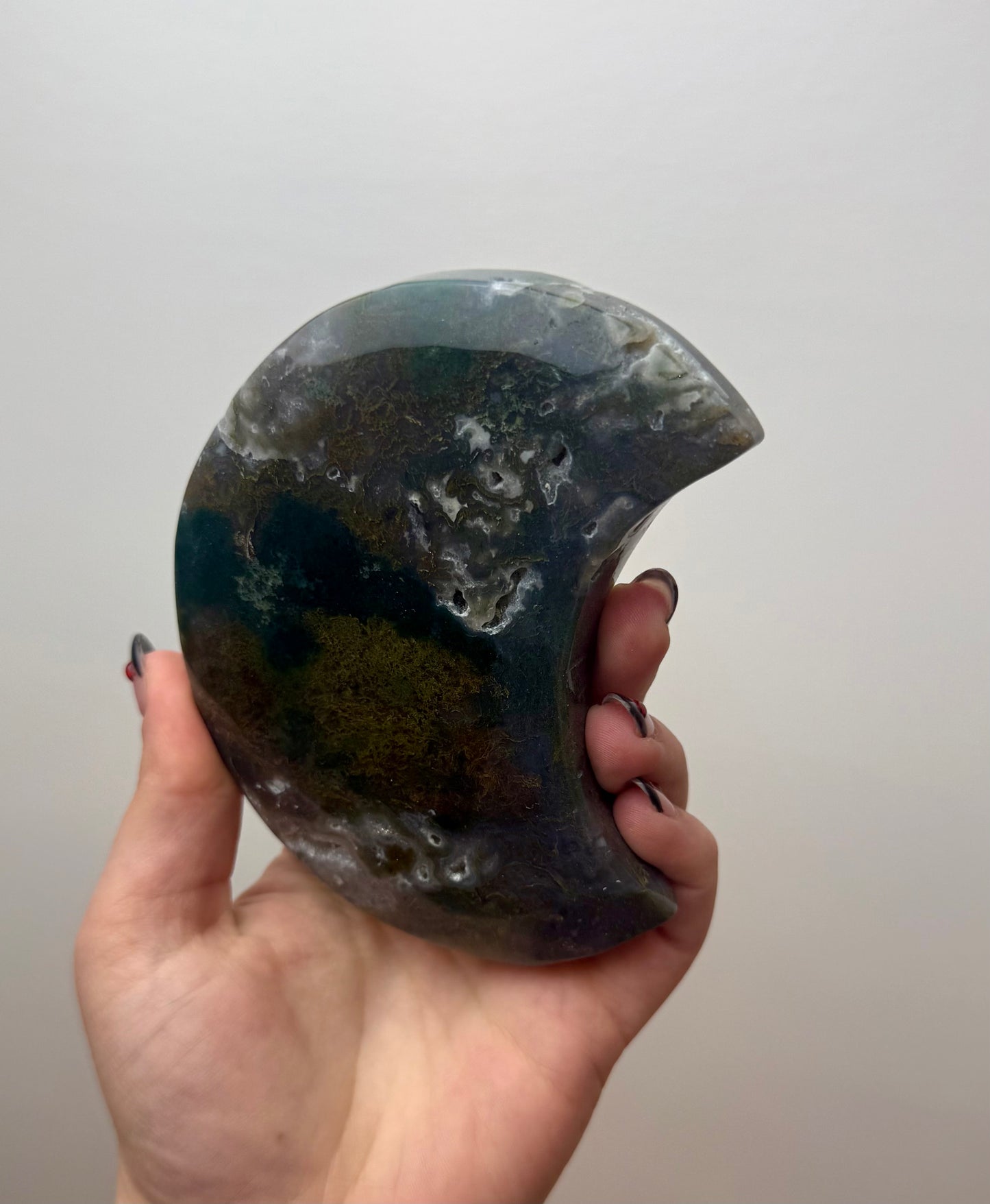 Moss agate moon carving on stand