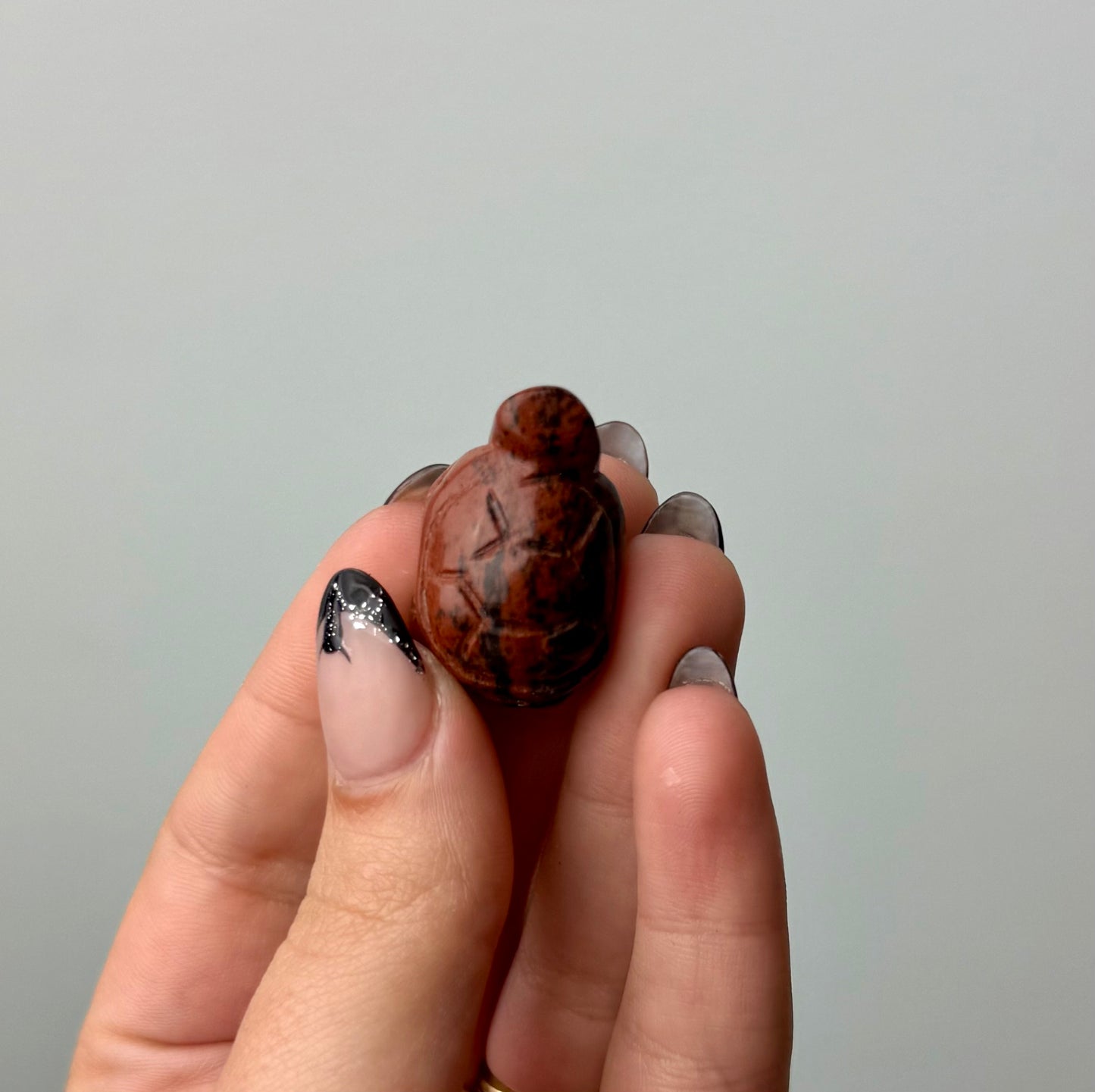 Mahogany obsidian turtle carving