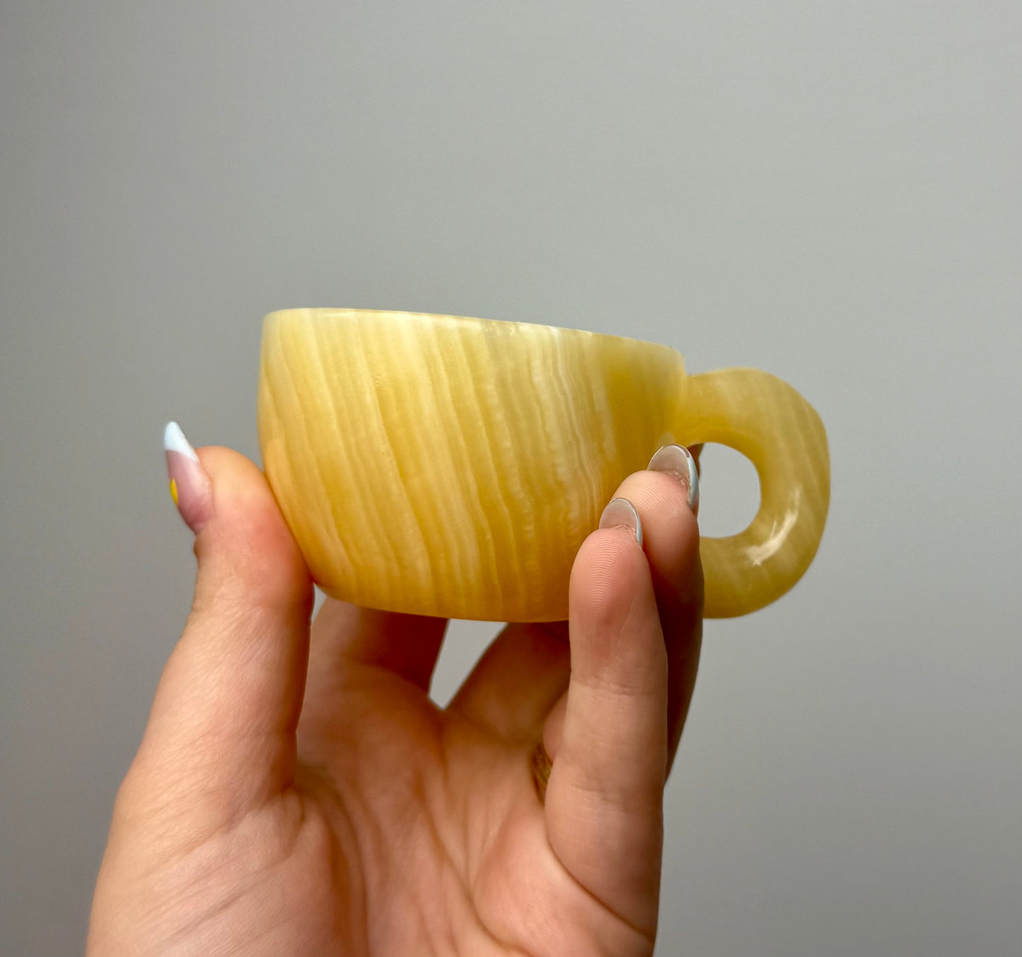 Orange calcite mug/cup carving