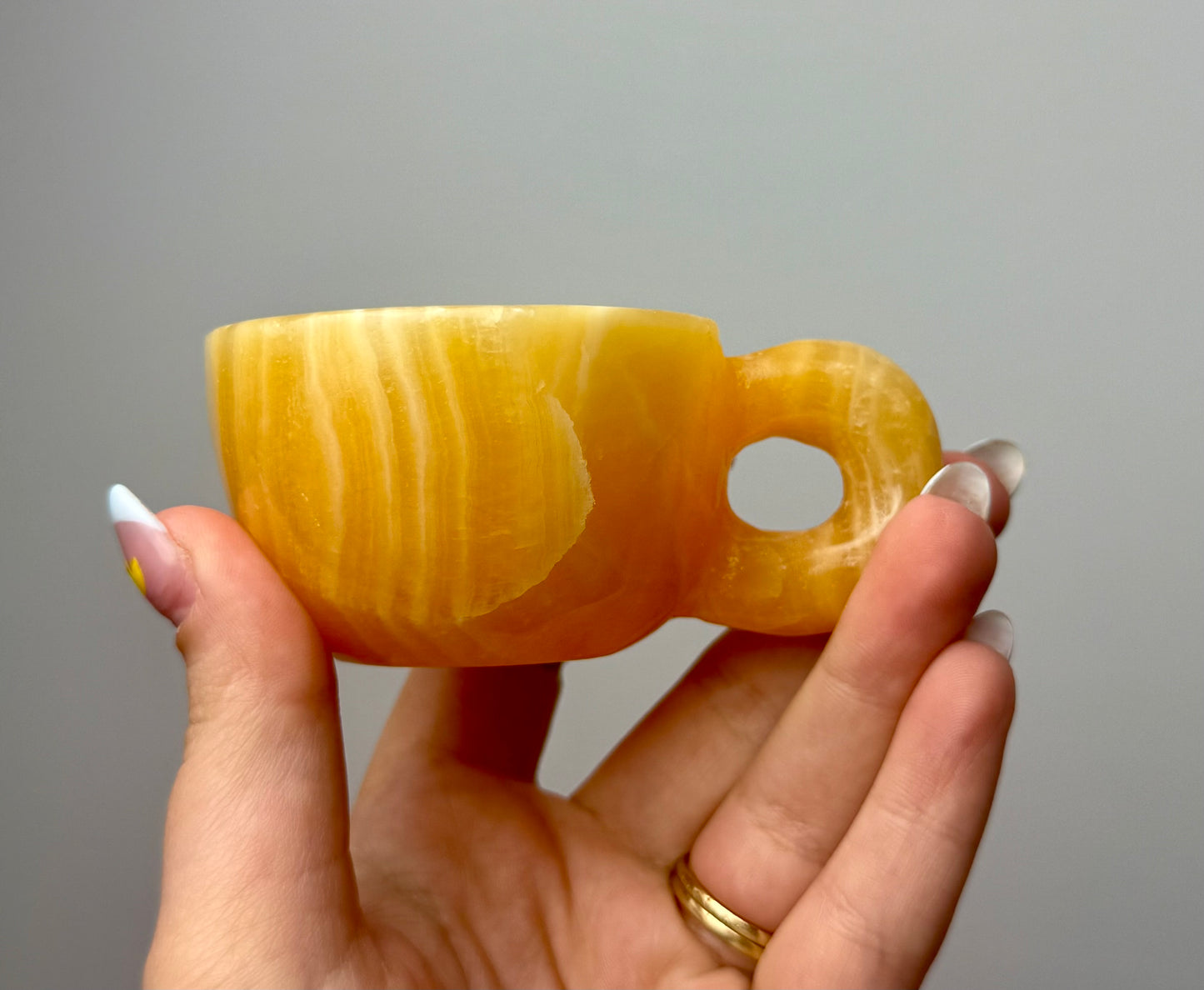 Orange calcite mug/cup carving