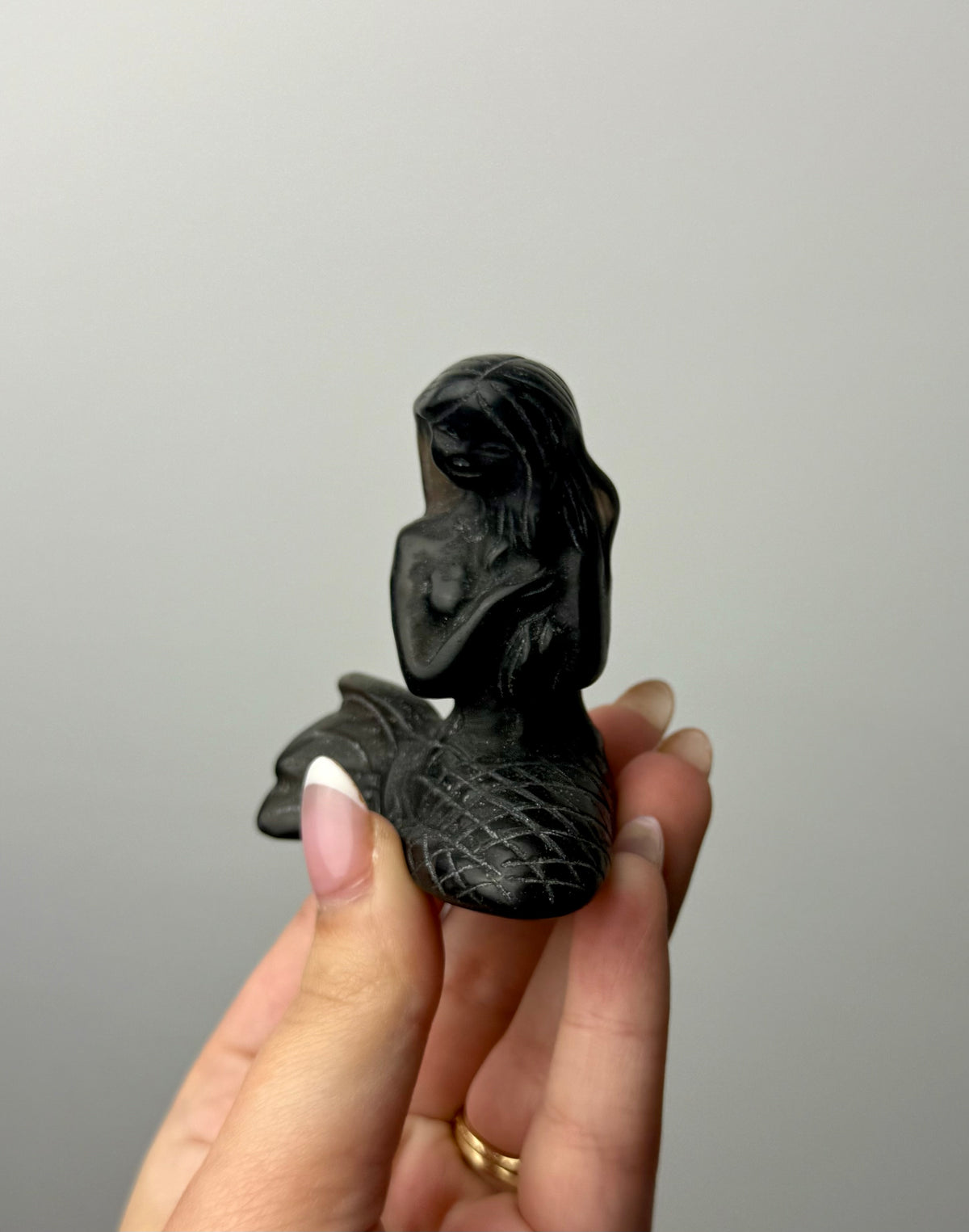 Obsidian mermaid carving