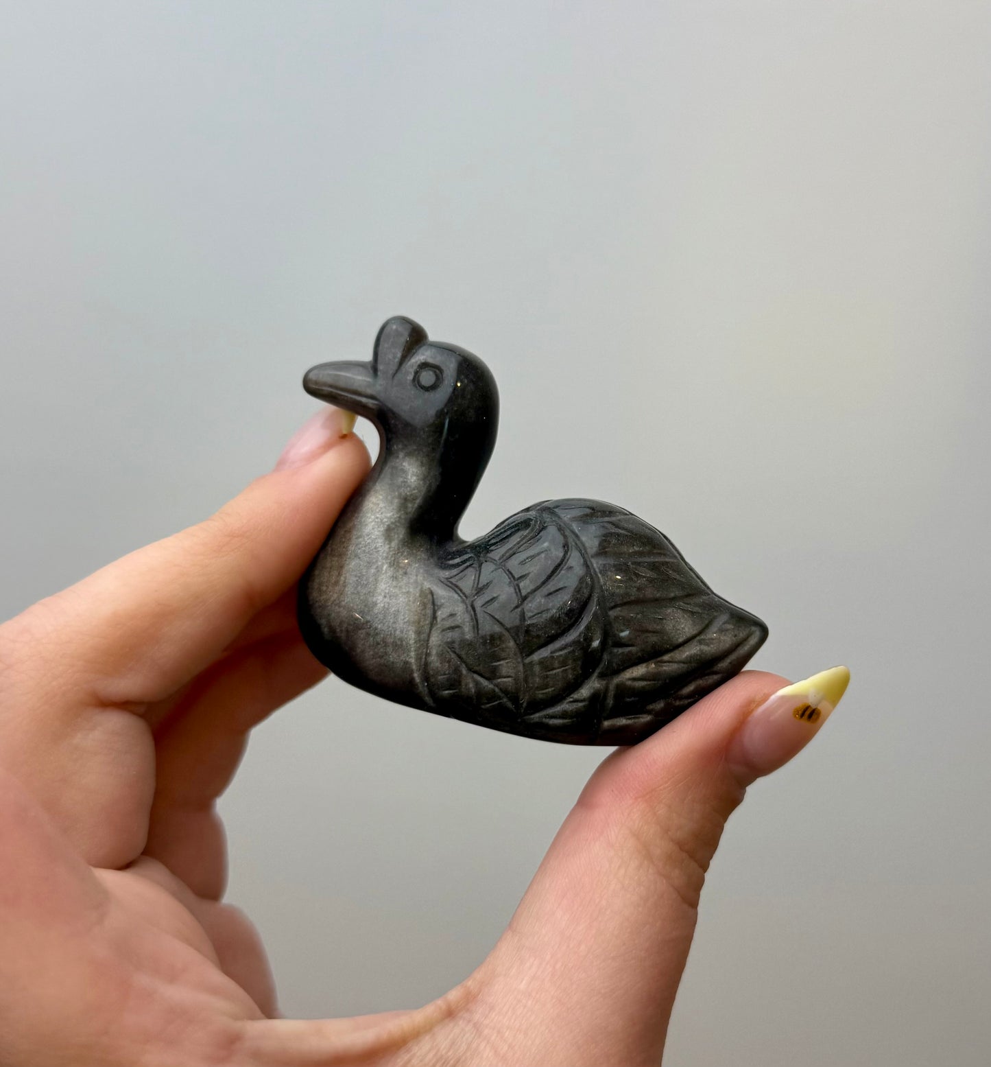 Silver obsidian swan carving