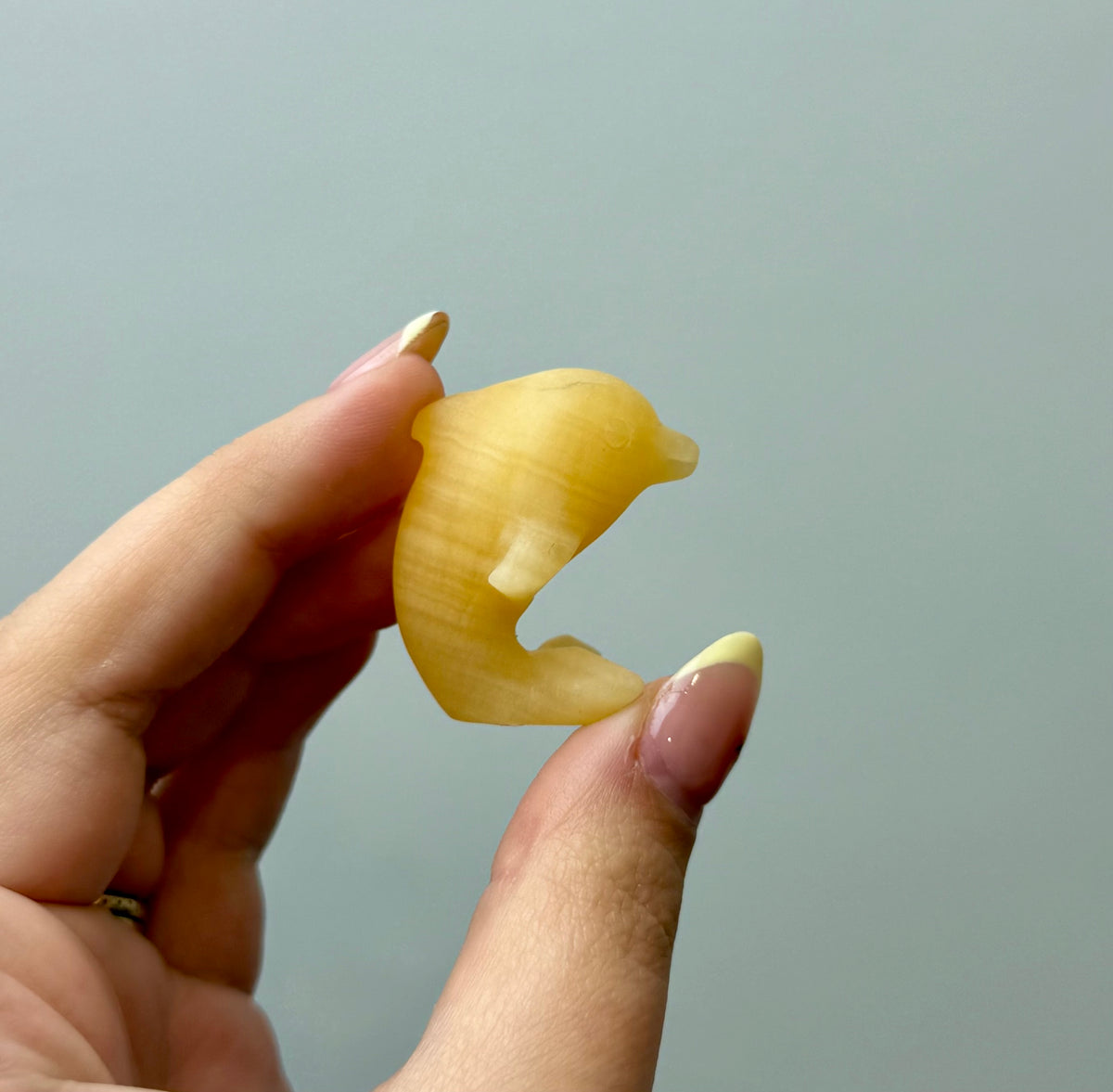 Orange calcite dolphin carving