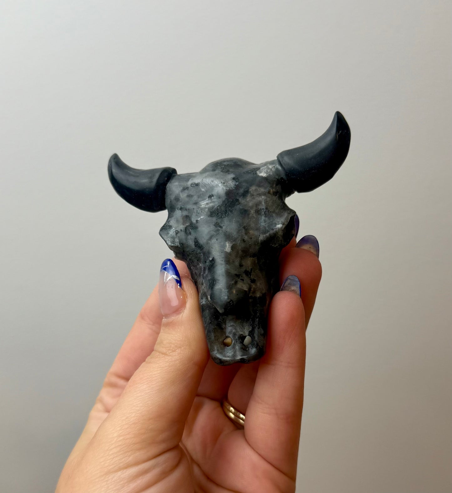 Larvikite cow skull carving