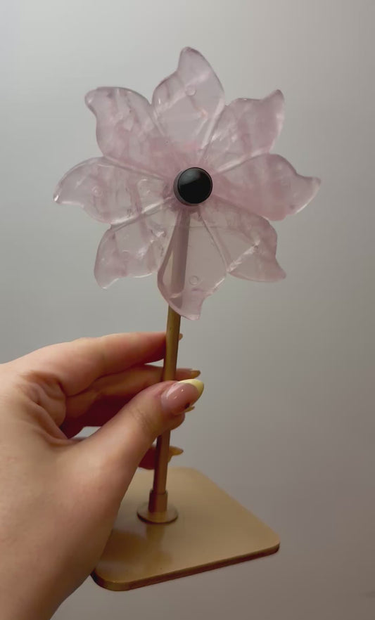 Rose quartz spinning flower carving on stand
